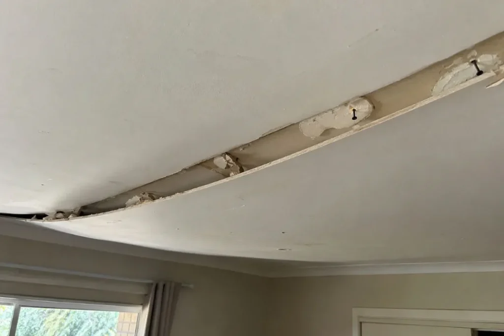 sagged old plasterboard ceiling